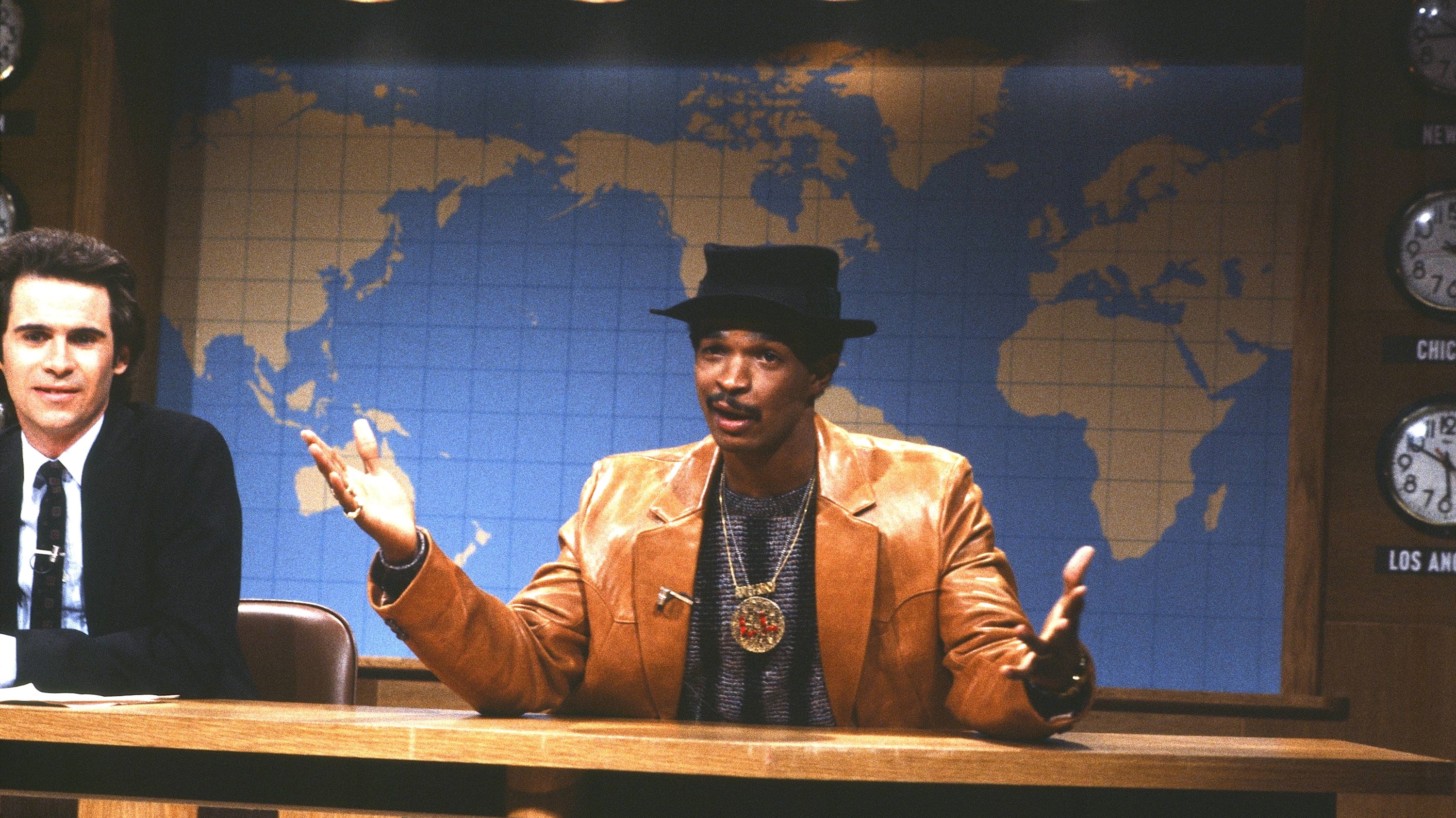 SATURDAY NIGHT LIVE -- Episode 4 -- Air Date 12/07/1985 -- Pictured: (l-r) Dennis Miller, Damon Wayans during Weekend Update on December 7, 1985 -- Photo by: Alan Singer/NBCU Photo Bank