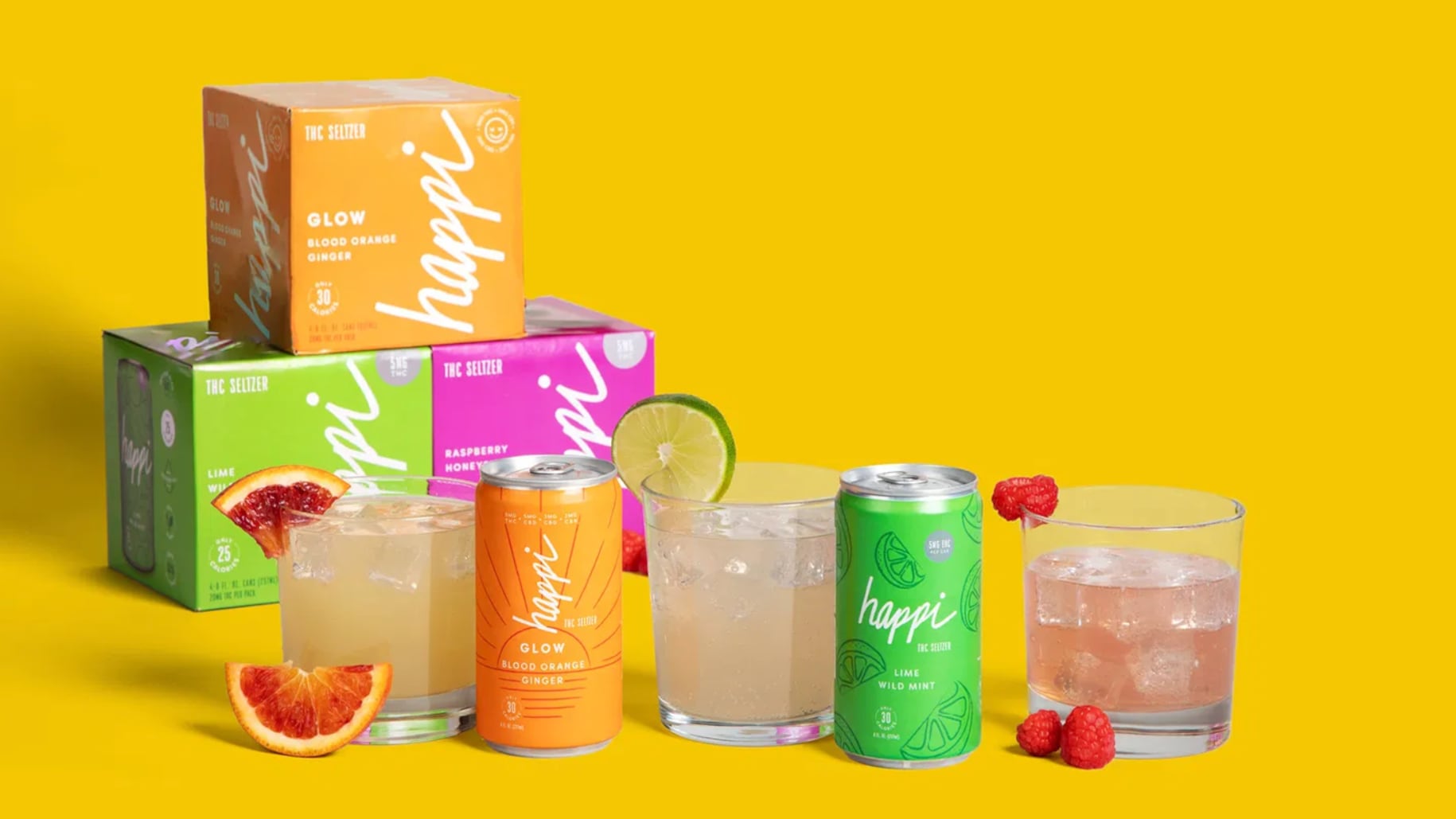 An assortment of Happi's Alcohol-Free THC drinks on a yellow background. There are two cans, one orange and one green. Three glasses filled with liquid and ice cubes. Plus, three boxes stacked on top of each other.