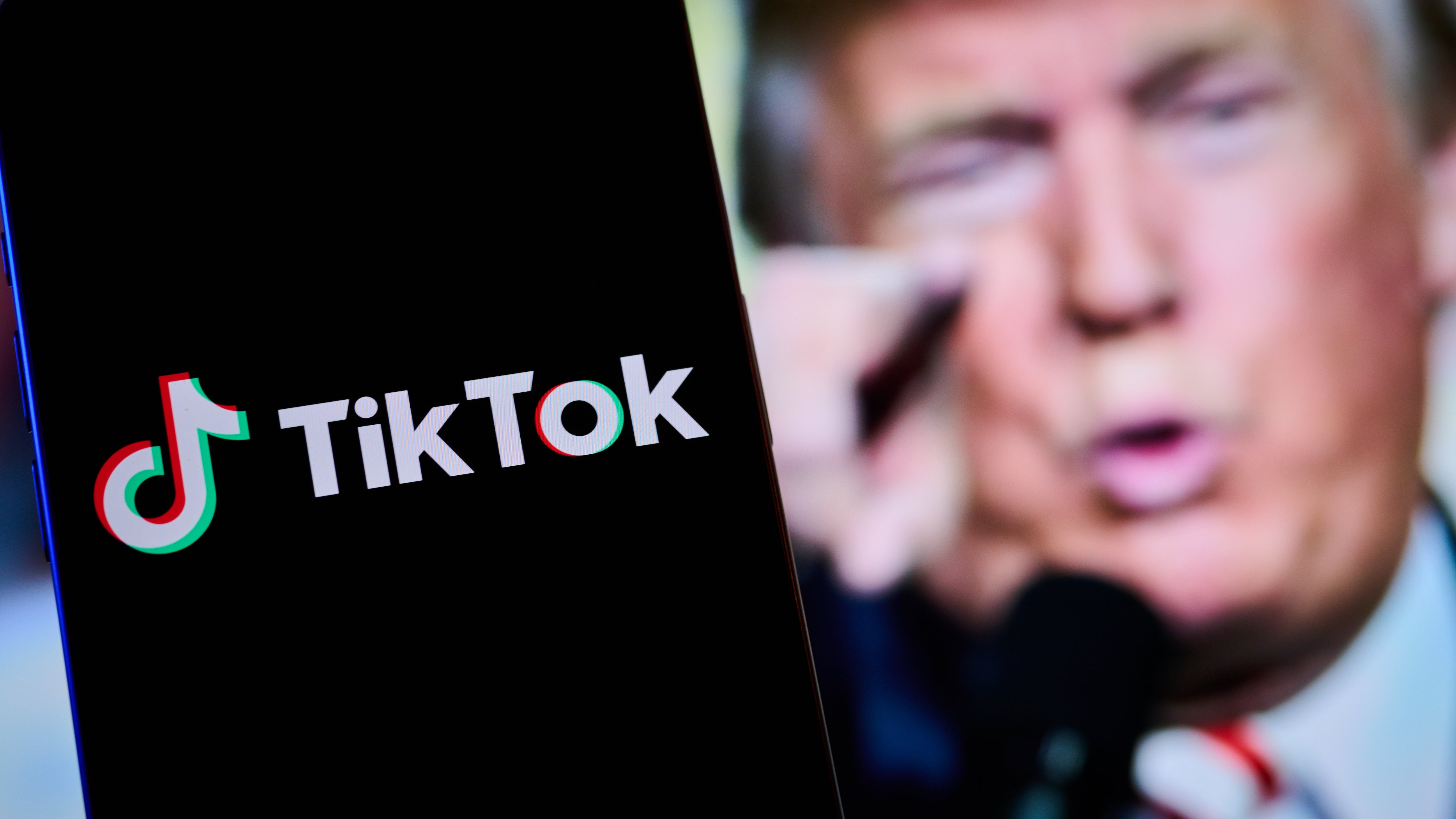 TikTok logo in front of a picture of President-elect Donald Trump.